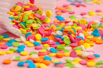 Sugar sprinkles  food background on pink cardboard