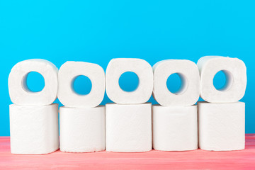 Toilet paper stack on bright blue background