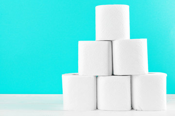 Toilet paper rolls on turquoise bright background