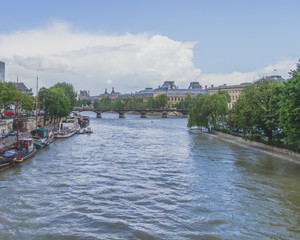 Obraz premium Seine river with bridge and boats in Paris, France
