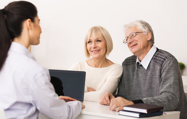 Senior couple visiting doctor and discussing their health