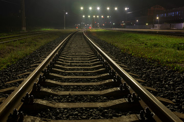 railway tracks in fog at night