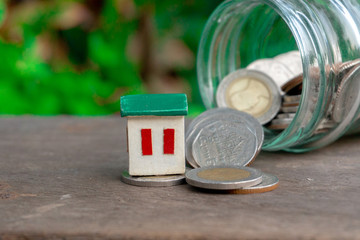 Collect coins in a dozen glass to save money to buy a house in the future.