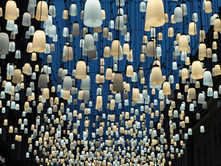 Fototapeta premium Beautiful bell-shaped lamps street illumination. Blue and yellow lanterns. Abstract background