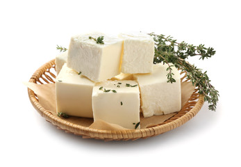 Plate with tasty feta cheese on white background