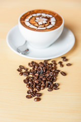 hot cappuccino with nice milk pattern on the table