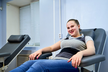 Woman who sitting on the couch in medical office