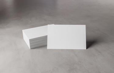 White business card stack on concrete desk 3D rendering