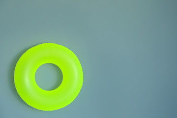 Bright inflatable ring on color background