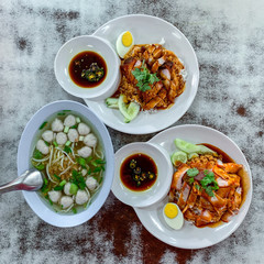Pork and red rice with pork balls on the old white wooden table top view