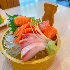 Salmon, tuna, sashimi included on the ice, using wooden containers Bring along with Wasabi in a Japanese restaurant.