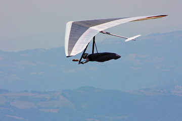Hang glider pilot in Italian mountains