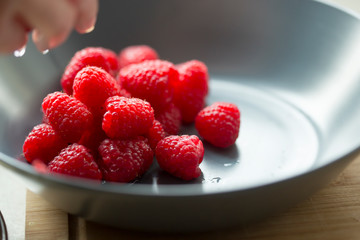 Fresh raspberries in bowl 