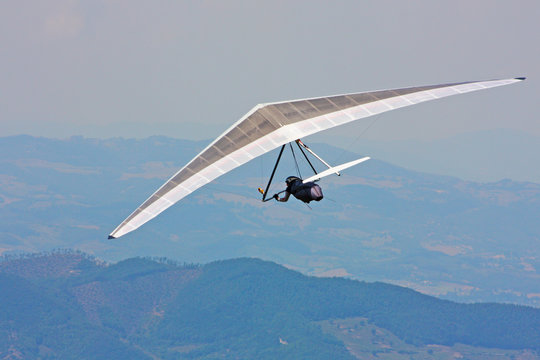 Hang glider pilot in Italian mountains