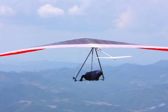 Hang glider pilot in Italian mountains