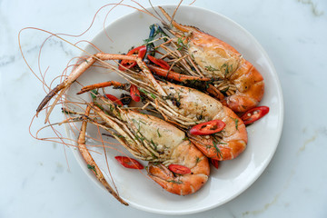 Fried king prawns with garlic and herbs, close up, Thailand