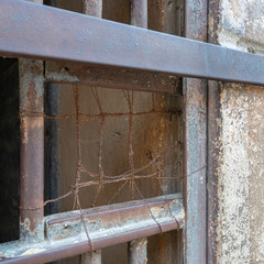 Closeup of a closed rusted iron bars of cell door in closed abandoned prison at Cairo Citadel, Egypt