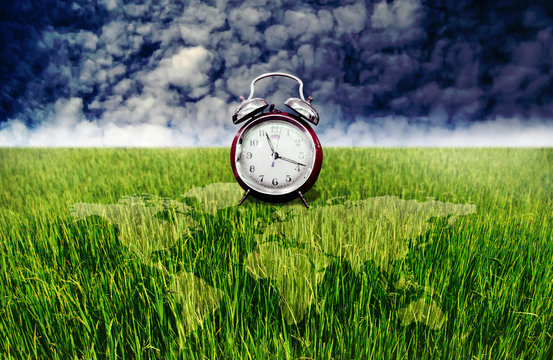 Alarm clock and green rice field with world map overlay, Time to plantation concept