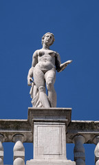 Fototapeta na wymiar Statue at the top of National Library of St Mark`s Biblioteca Marciana, Venice, Italy, UNESCO World Heritage Sites
