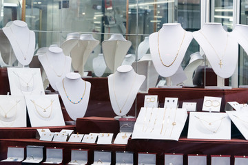 Jewelry diamond rings and necklaces show in luxury retail store window display showcase