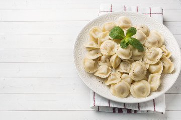 Dumplings stuffed with meat, ravioli, dumplings. Dumplings with stuffing. Russian cuisine. Copy space.