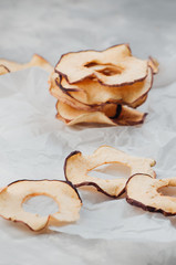 Dried apple slices on grey background