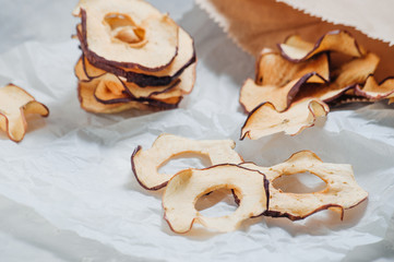 Dried apple slices on grey concrete background