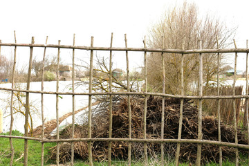 Twig fence at the countryside. Wicker fence