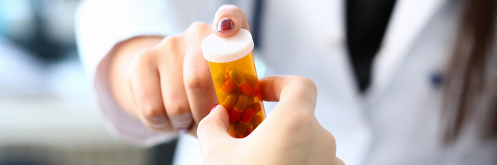Female medicine doctor hand hold jar of pills and © kuprevich