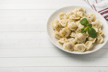 Dumplings stuffed with meat, ravioli, dumplings. Dumplings with stuffing. Russian cuisine. Copy space.