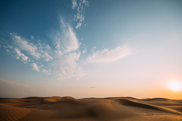 Desert with sand dunes on a clear sunny day. Desert landscape.