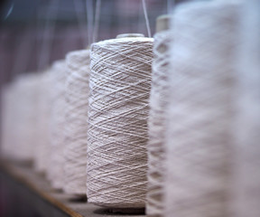 Row of textile threads industry .