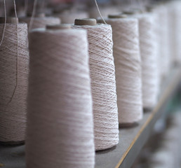 Row of textile threads industry .