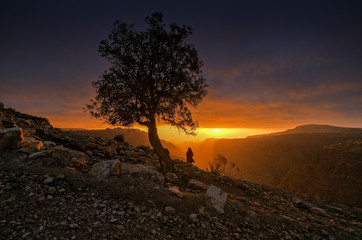 Dramatic orange sunset in Dana mountains in Jordan