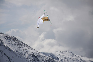 Naklejka na ściany i meble Flying skier on snowy mountains. Extreme winter sport, alpine ski.