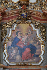 Fototapeta na wymiar Virgin Mary with baby Jesus, altarpiece in the Church of Assumption of the Virgin Mary in Pokupsko, Croatia