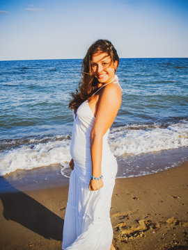 Simple tan arabic girl from small town, plus size young lady at nature. Portrait of voluptuous young woman posing sensually on ocean  background 
