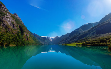 Fototapeta na wymiar Amazing nature view with fjord and mountains. Beautiful reflection. Location: Scandinavian Mountains, Norway.