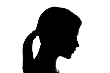 Dark silhouette profile of a young women on a white background, the concept of anonymity