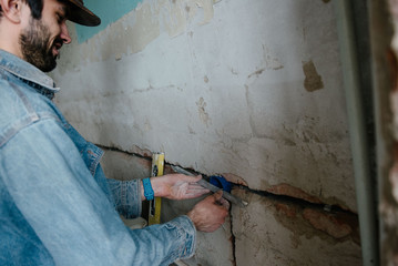 Worker inserts an electrical outlet box