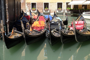 Fototapeta na wymiar View of moored gondolas and historical buildings in Venice, Italy 