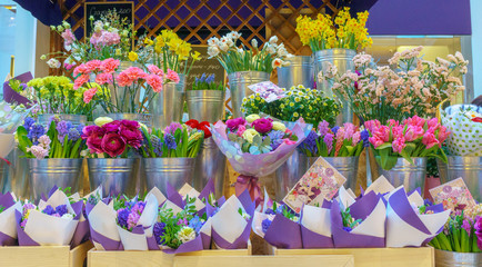 Fototapeta na wymiar Multicolored blooming cactus in pots in flower shop, selective focus