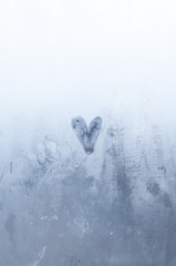  a drawn heart on the foggy window