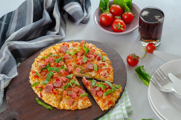 Slice of tasty pizza on the wooden board.
