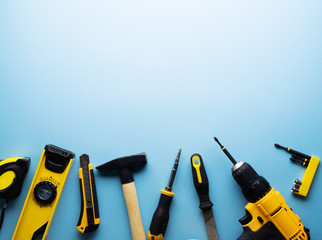 Creative provocation: a flat layout of yellow hand tools on a blue background.