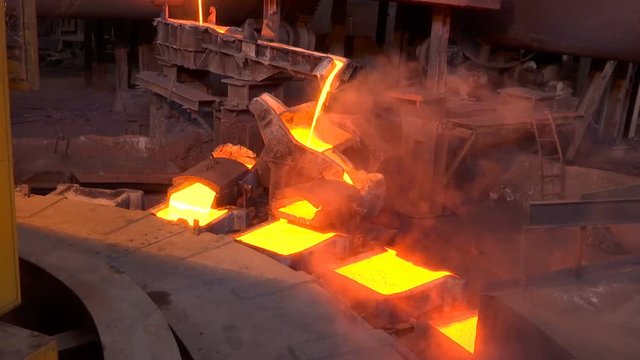Pouring Molten Copper Into Molds In A Foundry / Processing of copper ore in the foundry,liquid metal is poured into molds