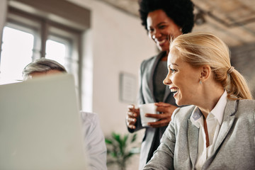 Happy businesswoman having fun with her colleagues at work.