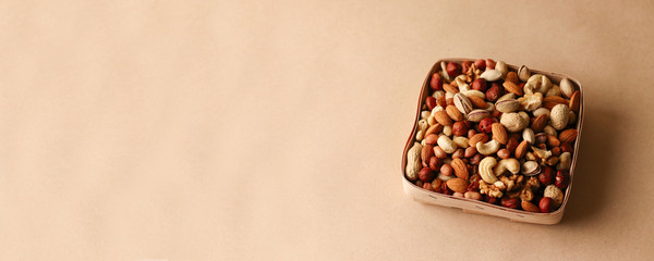 Dried fruits and nuts mix in a wooden bowl. 
