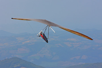 Hang glider pilot in Italian mountains
