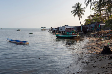 Boathouses and pollution on beach in Phu Quoc Island, Vietnam.